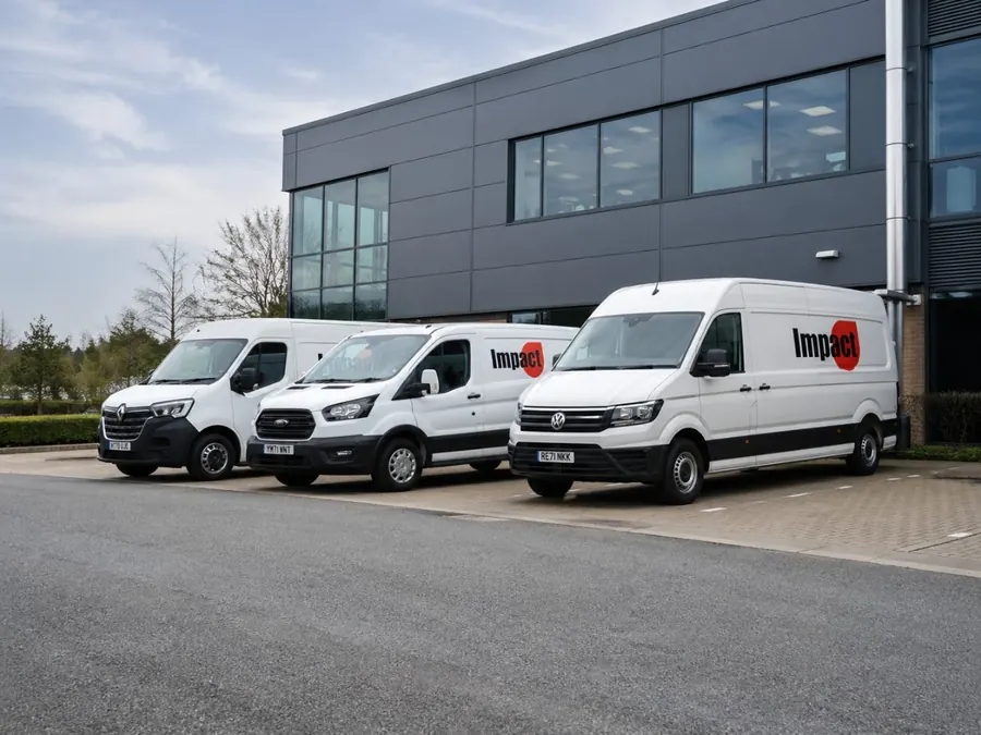 Impact Support Solutions vans parked outside a commercial building